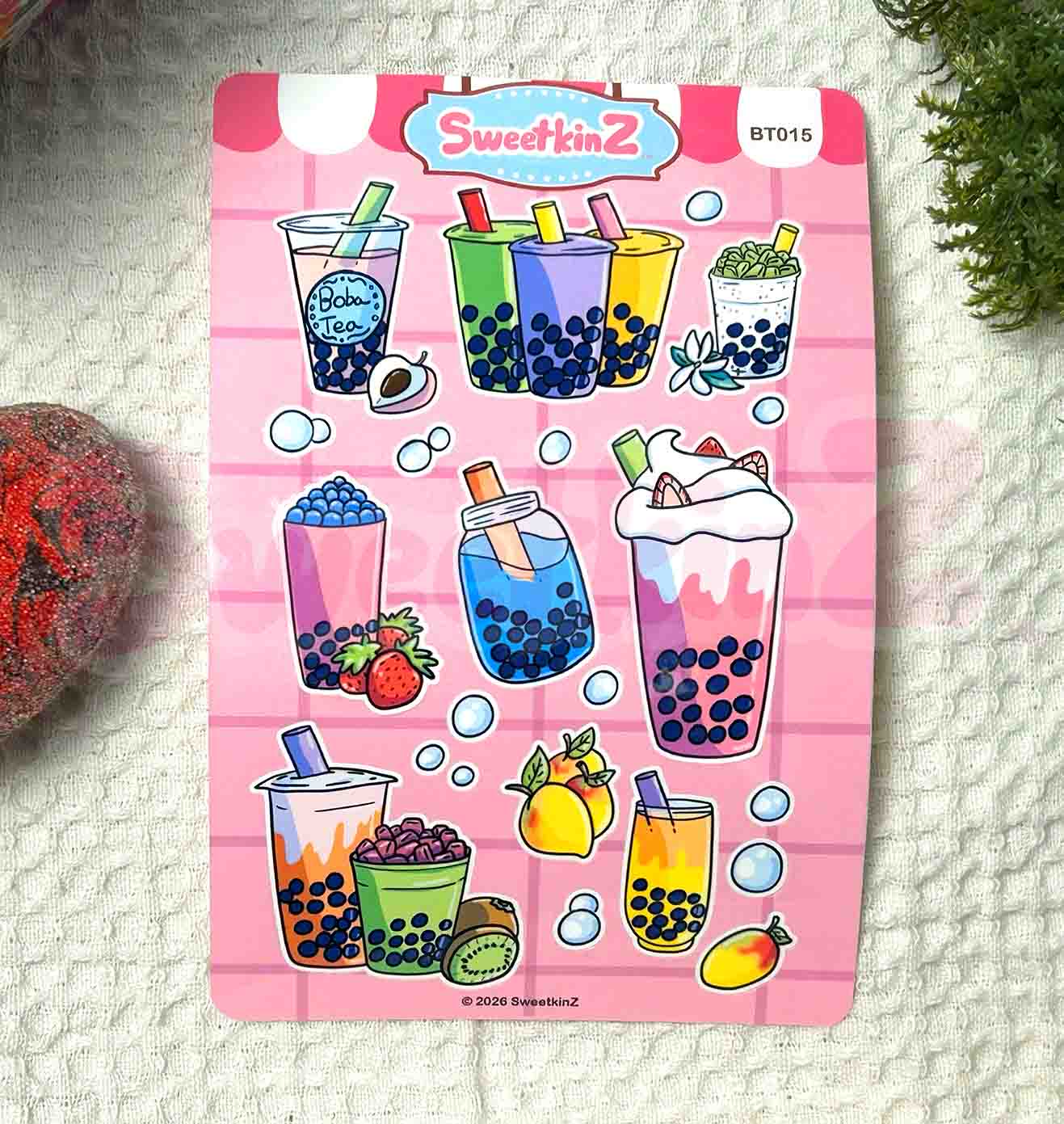 Sticker sheet with bubble tea designs on a pink and white checkered background