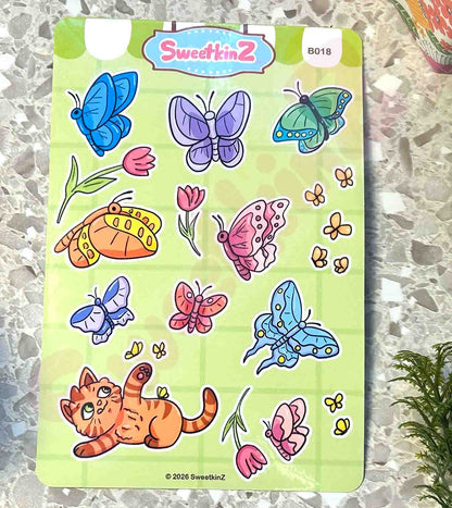 Sheet of colorful butterfly and cat stickers on a green backing with 'SweetkinZ' branding.