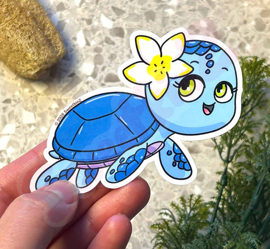 Cartoon turtle sticker with a flower on a textured surface