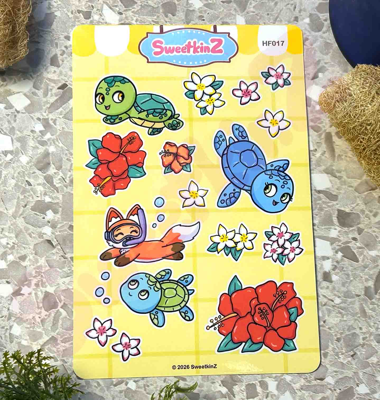 Sheet of colorful stickers featuring turtles, flowers, and a fox diver on a yellow backing with 'SweetkinZ' branding.