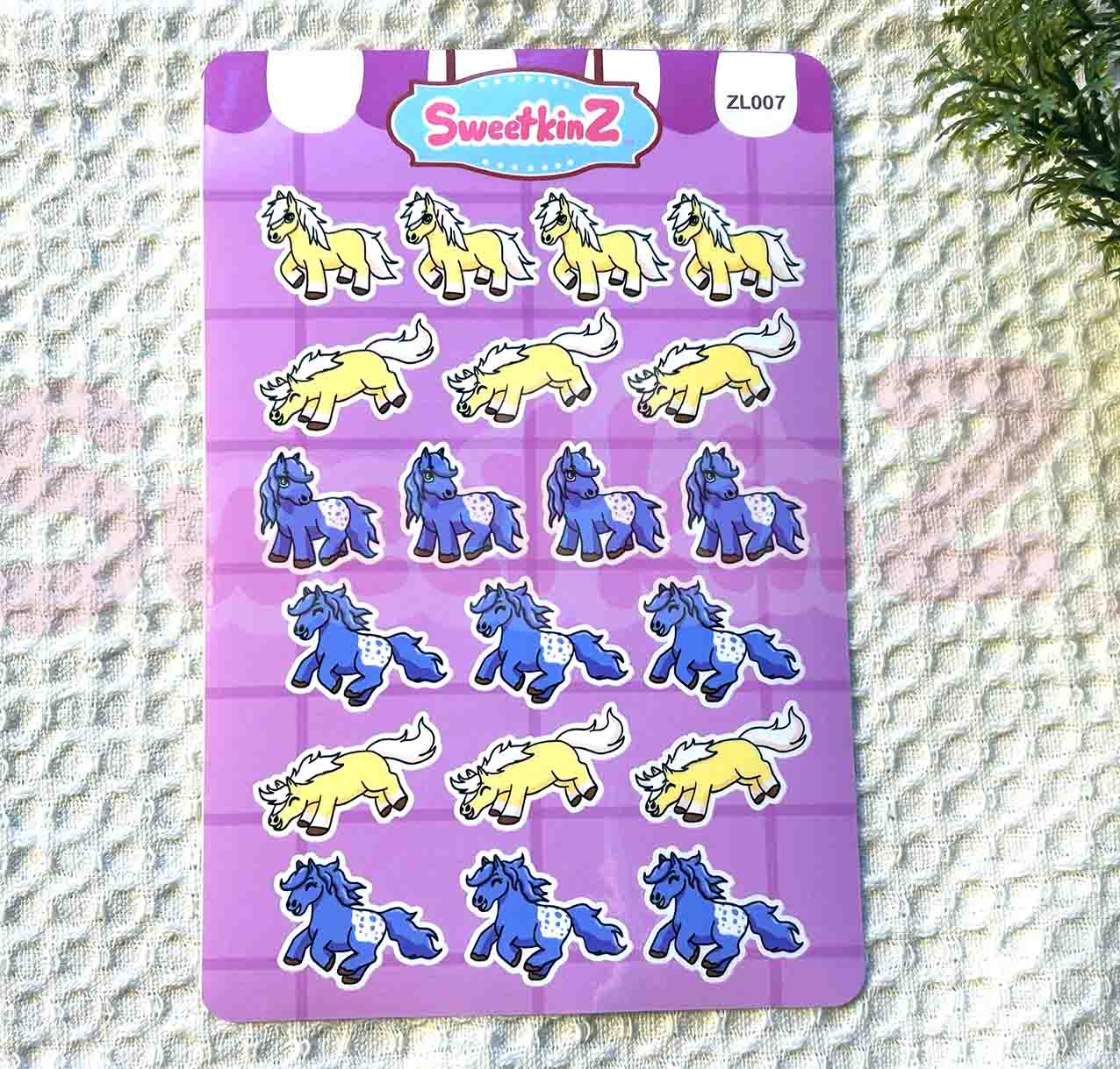 Sheet of horse-shaped stickers on a purple background with 'SweetkinZ' branding.