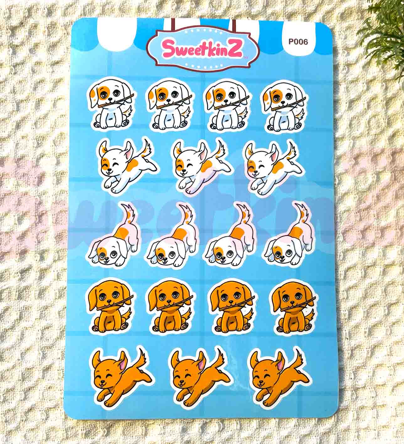 Sheet of dog-themed stickers with 'SweetkinZ' branding on a textured surface.